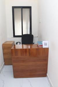 a wooden desk in a room with a window at Hotel CBD in Navi Mumbai