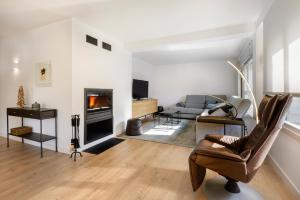a living room with a couch and a fireplace at Casa Estrimal, Panticosa, grandes familias y pequeños grupos in Panticosa