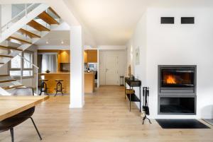 a living room with a fireplace and a staircase at Casa Estrimal, Panticosa, grandes familias y pequeños grupos in Panticosa