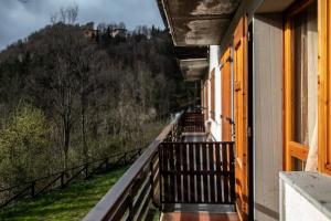 a balcony of a house with a view of a hill at Chalet Del Rio in Fiumalbo