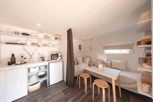 a kitchen and dining room with a table and chairs at Chalet dans le Perche in Soligny-la-Trappe