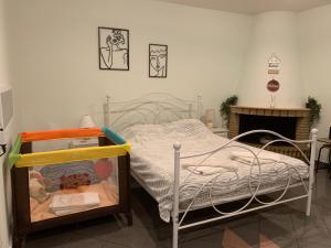 a bedroom with a bed and a fireplace at Eden Garden near Knossos in Skalánion