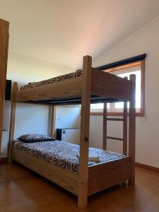 two bunk beds in a room with a window at Golden Waves Surf and Yoga Lodge Furadouro in Ovar