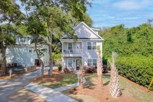a white house with palm trees in front of it at Spacious Charleston - 6 mins to beach & Downtown in Charleston