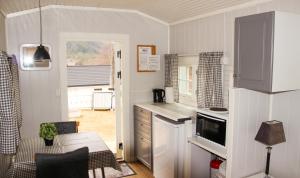 a kitchen with a sink and a counter top at Sandli Overnatting in Alvdal