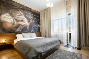 a bedroom with a large painting of a man with a beard at Castle Transylvania in Alba Iulia +46 photos