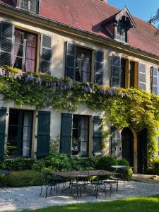 a building with a table and chairs in front of it at Chateau De Martigny in Poisson