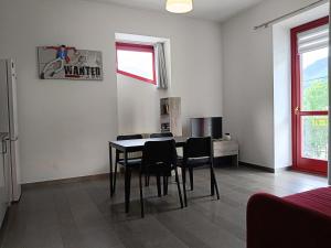 a dining room with a table and chairs at Liberty House Alps in Châtillon