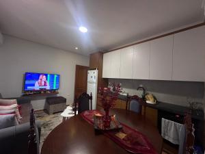 a living room with a table and a tv at Vila Mema 2 in Piqeras +21 photos