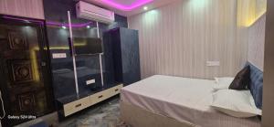 a bedroom with a bed and a tv on a wall at Residential Dream Inn Hotel in Muzaffarpur