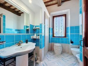 a blue and white bathroom with a sink and a toilet at Il Sentiero Del Poeta - Country House in Bagnola +57 photos