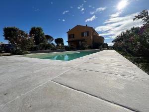 a house and a swimming pool in front of a house at Il Sentiero Del Poeta - Country House in Bagnola