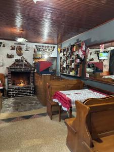 a room with a fireplace and a bedroom with a bed at Villa Zefi Rrenc in Shkodër