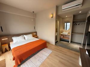 a bedroom with a bed and a bathroom with a sink at Brewstay in Luye