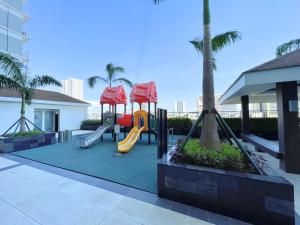 a playground with a slide at Charlie's Staycation at Coast Residences in Manila