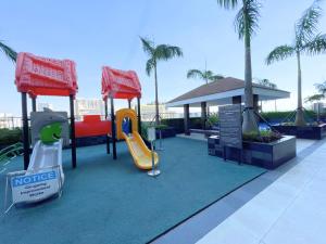 a playground at a resort with a slide and a slideintend at Charlie's Staycation at Coast Residences in Manila