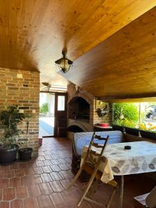 a living room with a table and a fireplace at Kuća za odmor Balog in Lipik