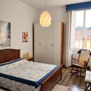 a bedroom with a bed and a pendant light at 50 m from the beach, Lerici-5 Terre, gulf view in Lerici