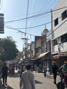 a group of people walking down a city street at SEVEN SEVEN HOMESTAy in Amritsar