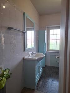 a bathroom with a sink and a mirror at Pintadera in San Giovanni