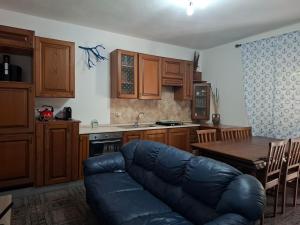 a living room with a couch and a table in a kitchen at Pintadera in San Giovanni