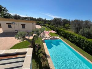 eine Draufsicht auf einen Swimmingpool vor einem Haus in der Unterkunft Villa Pergola in San Michele Salentino