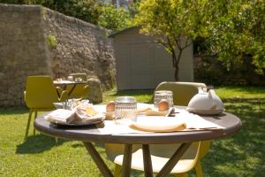 a table with eggs and plates on it in a yard at MILLE SUITE GARDEN in Noto