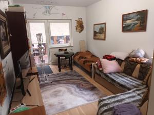 a living room with a couch and a table at Roberto ranch in Palanga