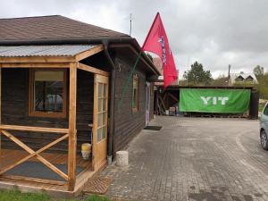 a building with a flag on the side of it at Roberto ranch in Palanga +2 photos