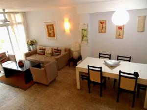 a living room with a table and a couch at Terrazas de Carilo 1A in Carilo