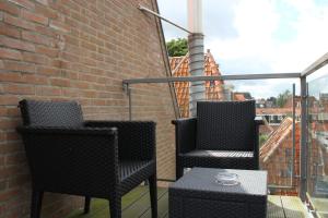 a chair and a table in a brick building at Hotel de Magneet in Hoorn
