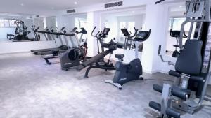 a gym with a bunch of treadmills and machines at Corfu Hotel in Ayia Napa