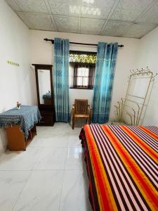 a room with two beds and a table in it at Dream Villa Homestay Madiha in Matara +9 photos