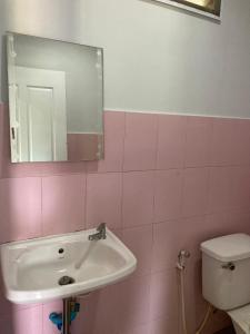 a bathroom with a sink and a toilet and a mirror at Sea Salt 2 Cozy Studio with full kitchen and Fast Wifi in Thong Sala