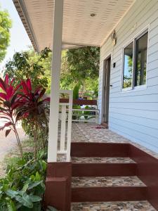 a porch with stairs leading to a house at Sea Salt 2 Cozy Studio with full kitchen and Fast Wifi in Thong Sala