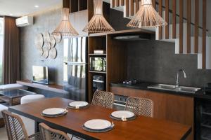 a kitchen with a table and chairs and a sink at Cozy 2BR Villa at Kedungu in Tabanan +3 photos