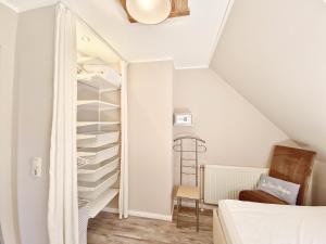 a staircase in a room with a closet at Ferienwohnung Deichblick in Neuharlingersiel