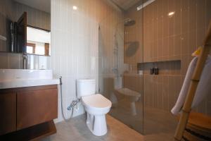 a bathroom with a toilet and a shower and a sink at Cozy 2BR Villa at Kedungu in Tabanan