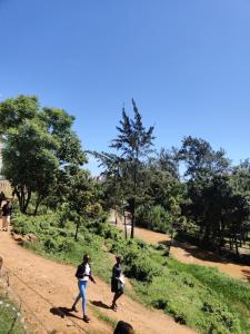 two people walking down a dirt road at Reigns cozy corner in Eldoret