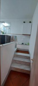 a staircase in a kitchen with white cabinets at Natura e spa in Cairo Montenotte