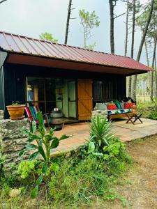 a small house with a porch and a couch on a patio at Mexican House in Cortesia