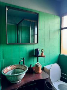 a green bathroom with a sink and a toilet at Mexican House in Cortesia +24 photos