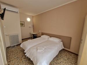 Albergo D'Ambros - Casa Belfiore Group客房内的一张或多张床位