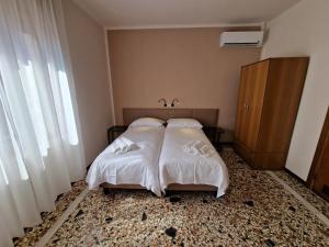 Albergo D'Ambros - Casa Belfiore Group客房内的一张或多张床位