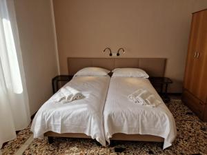 Albergo D'Ambros - Casa Belfiore Group客房内的一张或多张床位