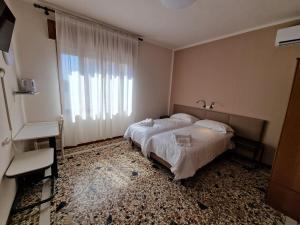 Albergo D'Ambros - Casa Belfiore Group客房内的一张或多张床位