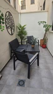Málaga Centro, 2 habs, Piscina en azotea, 2 terrazas y parking privado في مالقة: فناء مع طاولة وكراسي على الفناء