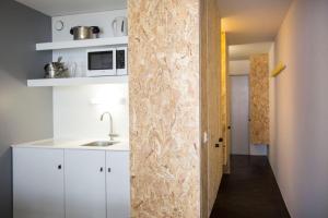 a kitchen with white cabinets and a marble wall at Résidence Le Varet - Arcs 2000 in Arc 2000 +12 photos