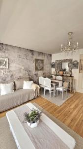 a living room with a couch and a table at Tatrzańska Prowansja SPA&SKI Apartament in Zakopane +64 photos