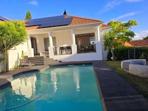 a house with a swimming pool in front of a house at Die Regte Rede in Cape Town